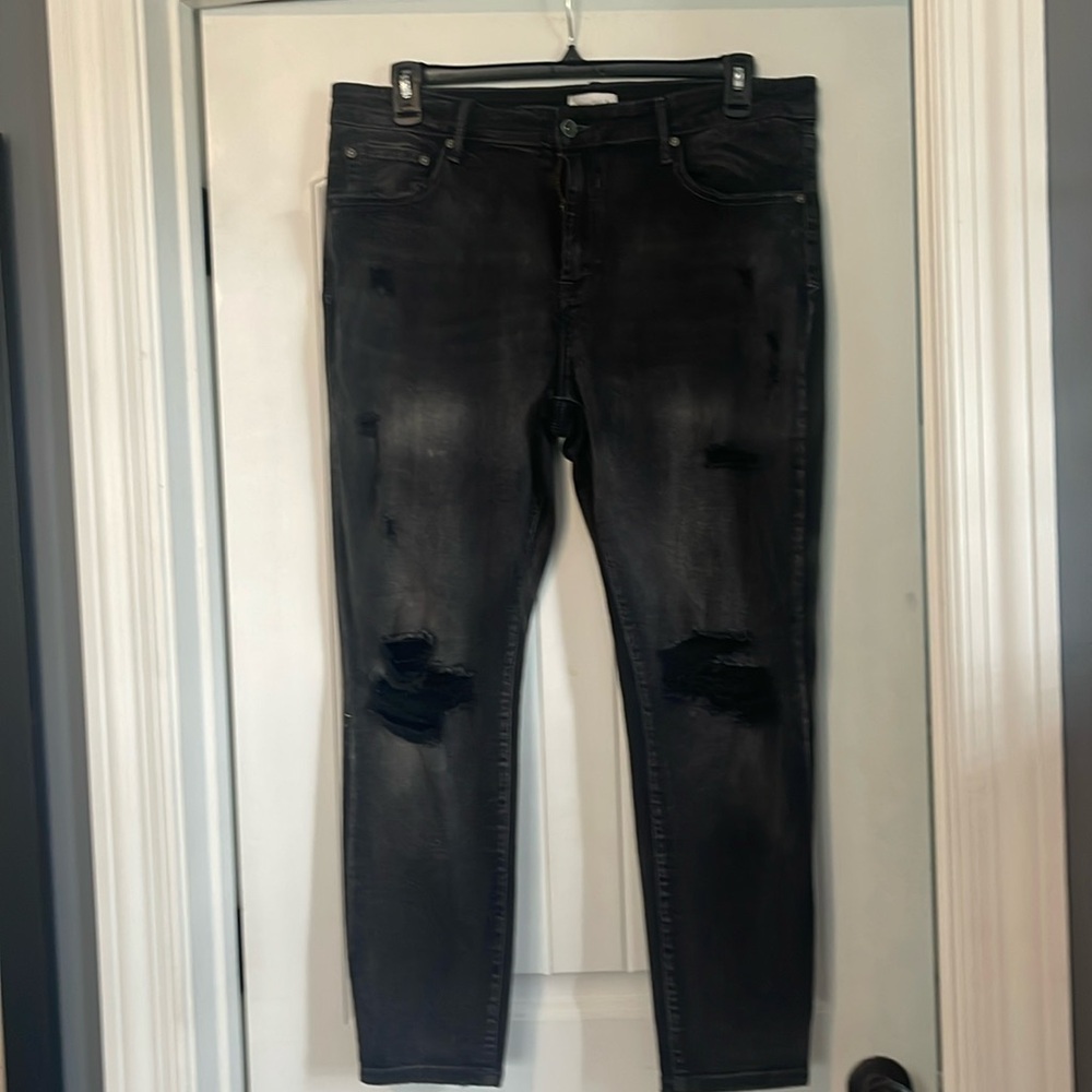 Brand new! Black jeans with holes.